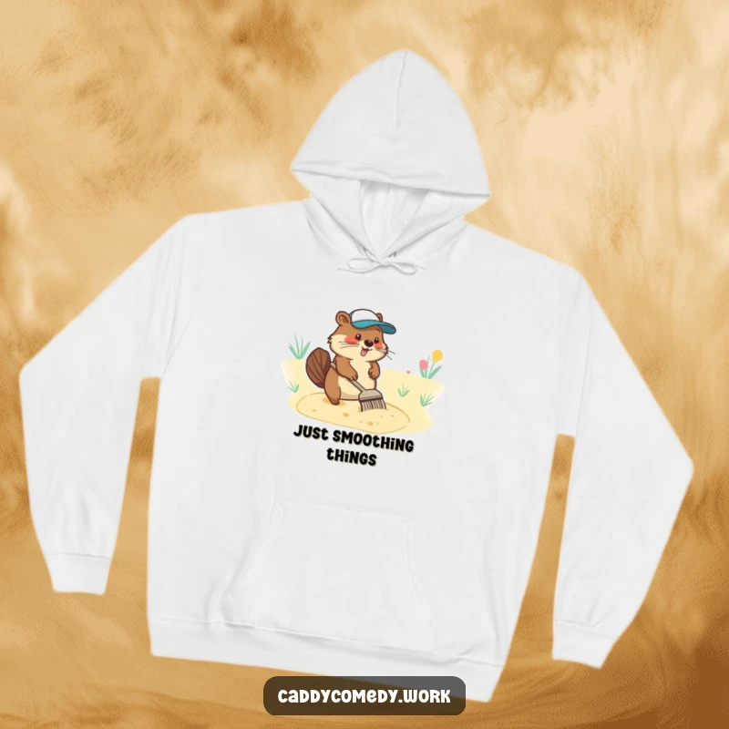 Funny hoodie featuring a diligent beaver character focused on raking a sand trap, embodying golf course care.