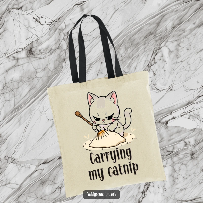 Funny tote bag featuring a cat character meticulously raking a sand trap, perfect for carrying items with focus.